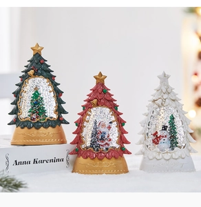 Detailed view of Christmas tree water globes with festive figurines on vintage bases