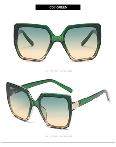 Detail of green transparent cat eye sunglasses with rhinestone accents and gradient lenses