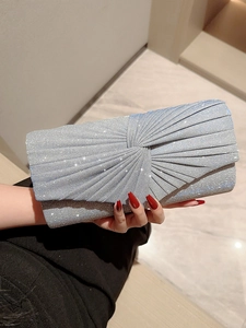 Silver pleated evening clutch bag with sparkling sequins and centered knot design