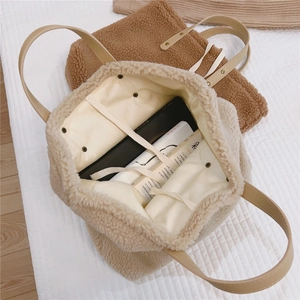 Detail of soft teddy fleece tote bags with leather handles and drawstring closure