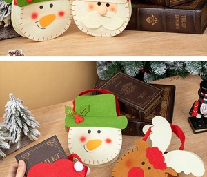 Detailed view of festive Christmas felt gift bags with snowman and reindeer characters