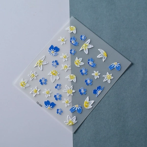 Macro shot of blue and white 3D floral embossed nail stickers TS-099 with relief texture
