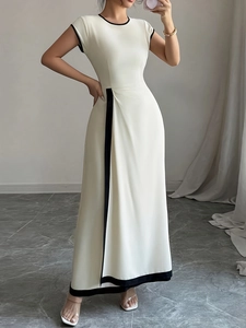 Detail of elegant cream sleeveless midi dress with black contrast trim and tailored waistline