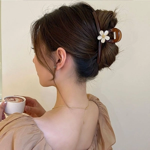 Elegant flower hair claw clip in dark brown with a white floral design for women