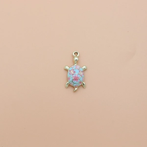 Detail of light blue enamel turtle pendant with pink cherry blossom pattern and gold alloy