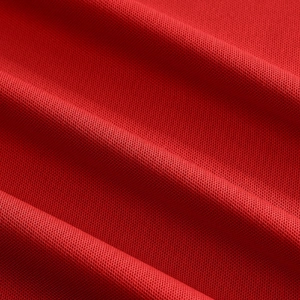 Macro shot of red honeycomb knit mesh fabric detailing breathable texture and quality