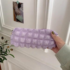 Detailed shot of lavender plissé textured pencil case with soft bubble fabric and zipper