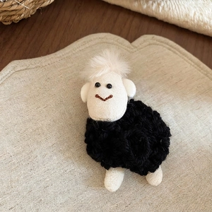Cute handmade plush lamb brooch with black crochet body and beige fabric head for fashion