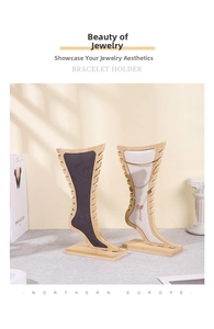 Bamboo jewelry display stand featuring gray velvet inserts and side notches for bracelets