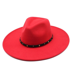 Detail of red wool felt fedora featuring 9.5cm wide brim and black studded band accent