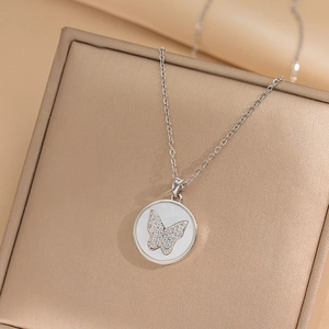 Silver butterfly necklace with white mother-of-pearl pendant on a luxury gift box