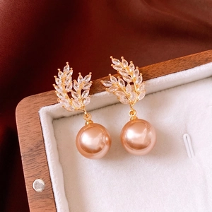 18K gold plated leaf-shaped drop earrings with champagne pearls in a jewelry box
