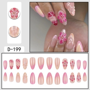Short almond press on nails with 3D pink flowers and gradient pearls design