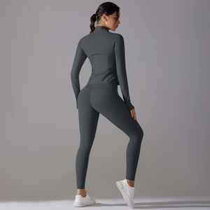 Slim fit dark grey yoga set featuring long sleeve zip jacket and high waist leggings