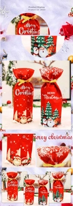 Detail of red Christmas wine bottle cover with cartoon Santa Claus and Merry Christmas print