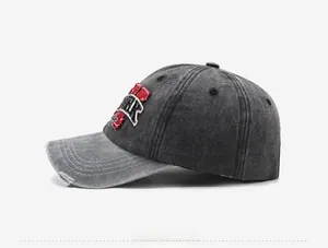 Detail of distressed brim and York embroidery on washed denim baseball cap