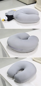 Macro detail of U-shaped travel pillow with zipper for penguin plush toy transformation