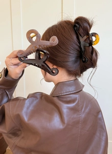 Elegant large butterfly hair claw clips in assorted colors styled on model's hair