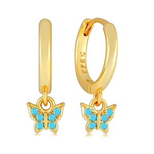 Detail of golden S925 sterling silver hoop earrings with blue stone butterfly charms