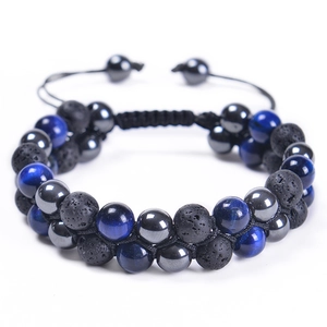 Macro detail of blue tiger eye, lava rock and hematite beads in double-layer braided bracelet
