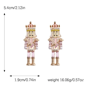 Detailed view of pink nutcracker earrings with size markers and faux pearl accents