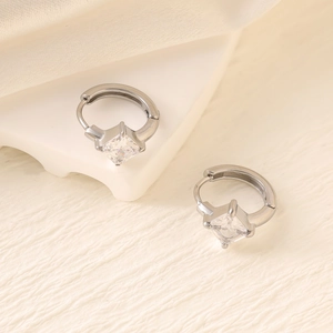 Detail of silver hoop earrings featuring square princess-cut cubic zirconia settings