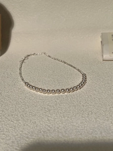 Detailed view of pearl and silver chain necklace with lobster clasp and extender