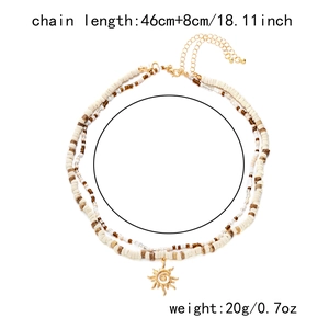 Detail showing dual-layer beaded necklace with sun pendant, 46cm length and 20g weight