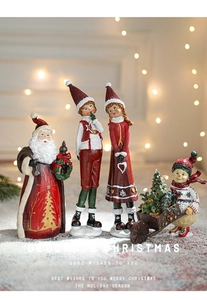 Close-up of resin Christmas figurines including Santa and elves in festive holiday setting
