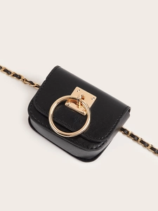 Minimalist black leather mini bag with gold ring accent and chain strap on beige background