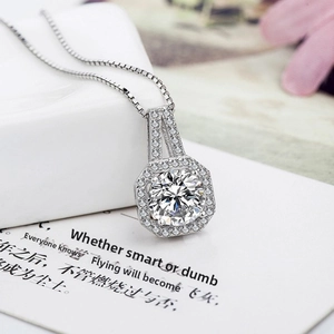 Detailed side view of 2ct zircon pendant with octagonal halo and cross chain