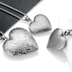 Detailed view of silver heart locket necklaces with floral, diamond and wave engravings