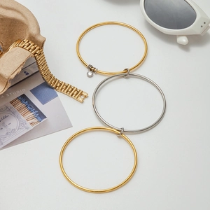 Three-piece stackable mixed metal bracelets with zircon charm on white background
