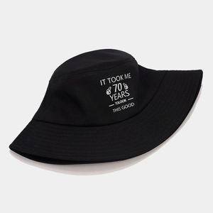 Detail of black cotton bucket hat with IT TOOK ME 70 YEARS TO LOOK THIS GOOD print