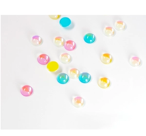 Close-up of colorful translucent round nail art rhinestones with iridescent finish