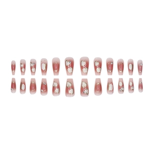 Pink gradient long coffin press-on nails with white heart patterns and sparkling rhinestones