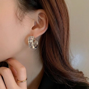 Silver C-shaped earrings with sparkling cubic zirconia on a model for a luxury look
