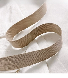 Detail of a khaki woven adjustable shoulder strap with refined twill texture for tote bags