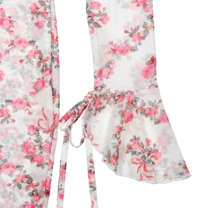 Détail de la manche en dentelle mesh blanche avec imprimé floral rouge et lien à nouer