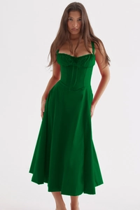 Detail of a dark green corset-style midi dress with thin straps and a pleated bodice