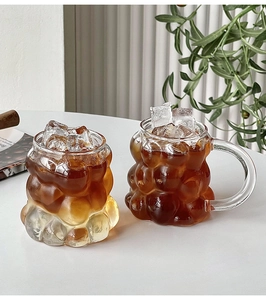 Close-up of heat-resistant bubble texture glass cups with coffee and ice cubes