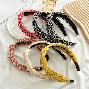 Detailed embroidery floral knot headbands in six colors displayed on a white cloth