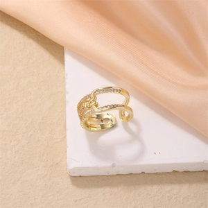 Elegant gold-plated adjustable ring with pink pavé crystals on a textured white stone