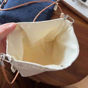 Detail view of cotton linen crossbody bag with magnetic snap and brown leather strap