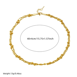 Gold plated stainless steel chain link necklace with beads on white background