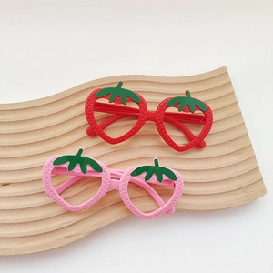 Cute strawberry-shaped children's eyeglass frames in red and pink with leaf details
