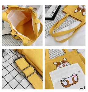 Detail view of yellow canvas tote bag with corgi print, zip closure, and adjustable strap