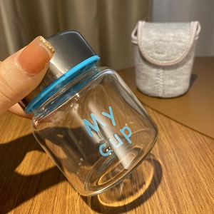 Detailed view of 150ml glass jar with MY CUP print, blue silicone ring and metal lid