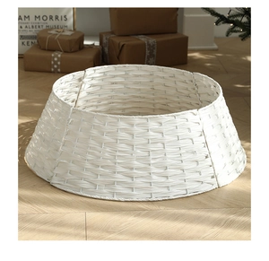 Detailed view of hand-woven white wicker Christmas tree collar on wooden floor