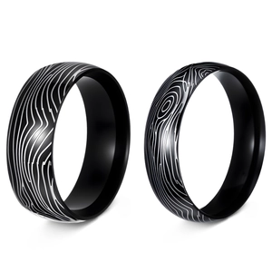 Detailed macro view showing Damascus steel texture on 6mm and 8mm titanium ring bands